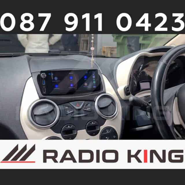 Android car radio with CarPlay system installed in vehicle dashboard featuring touchscreen display.