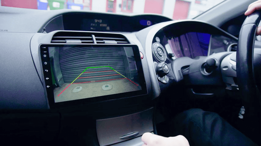 Reverse camera display on a car dashboard with integrated Android car radio system.