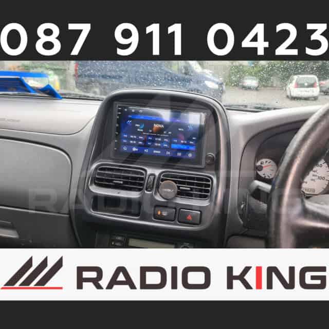Android car radio display with digital touchscreen interface and Radio King branding on a vehicle dashboard.