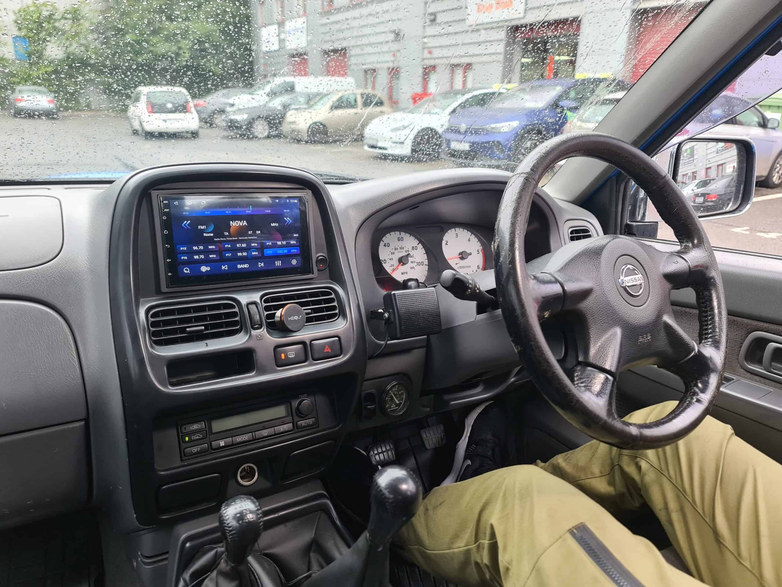 Android car radio with CarPlay system installed in vehicle dashboard, featuring touchscreen display.