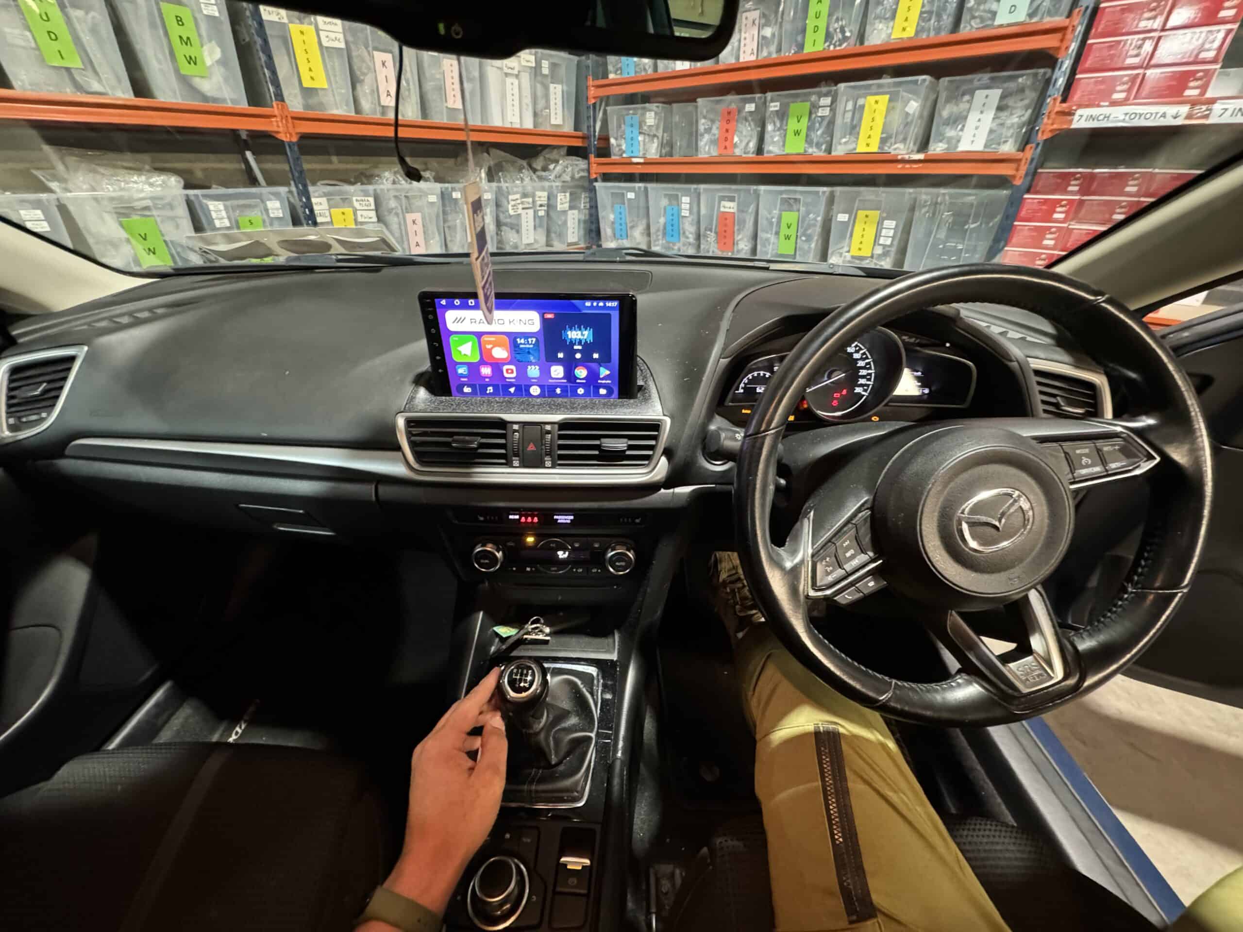 Android car stereo with CarPlay system installed in a Mazda vehicle.