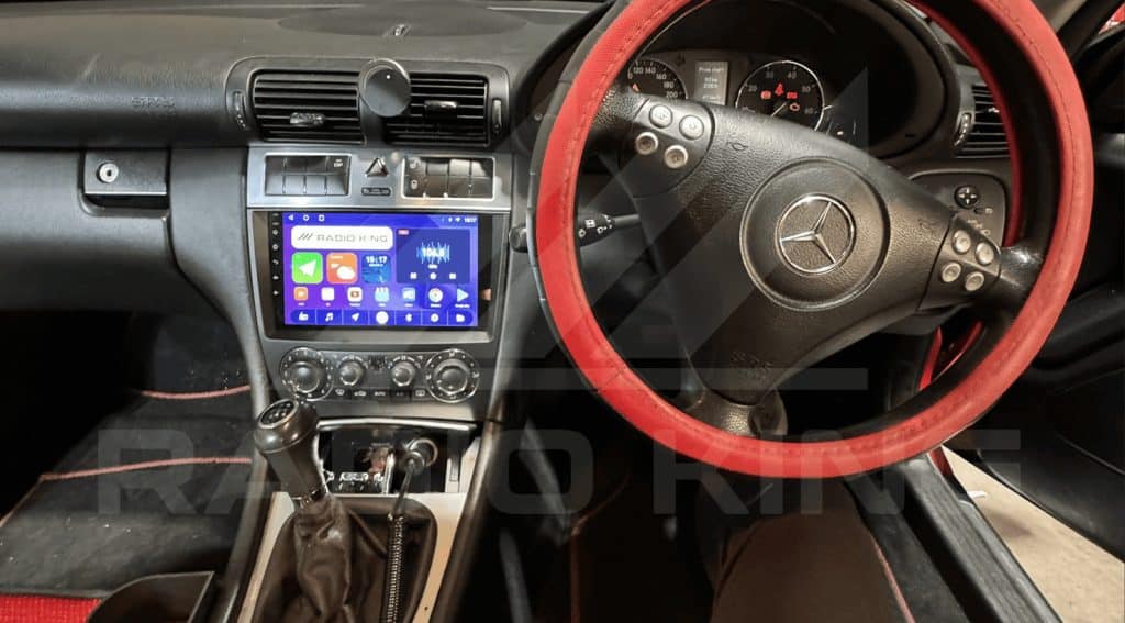 Radio king Ireland Android car radio system with CarPlay in a Mercedes-Benz interior, featuring a touchscreen display and steering wheel controls.