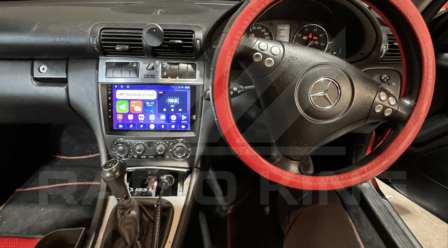 Radio king Ireland Android car radio system with CarPlay in a Mercedes-Benz interior, featuring a touchscreen display and steering wheel controls.