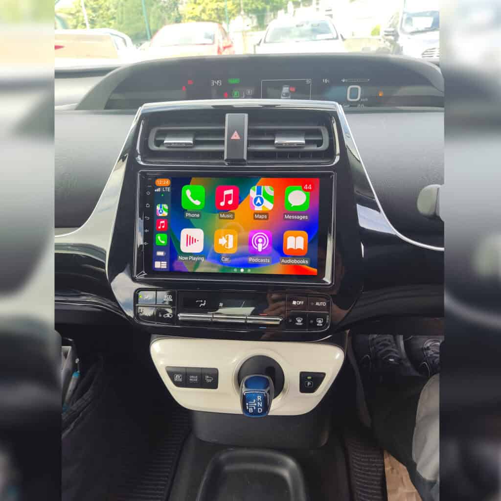Android car radio display with Apple CarPlay system in a vehicle cockpit.