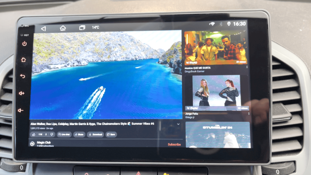 Laptop-style car radio with advanced touchscreen display showing YouTube video and music interface, installed in vehicle dashboard for multimedia entertainment.