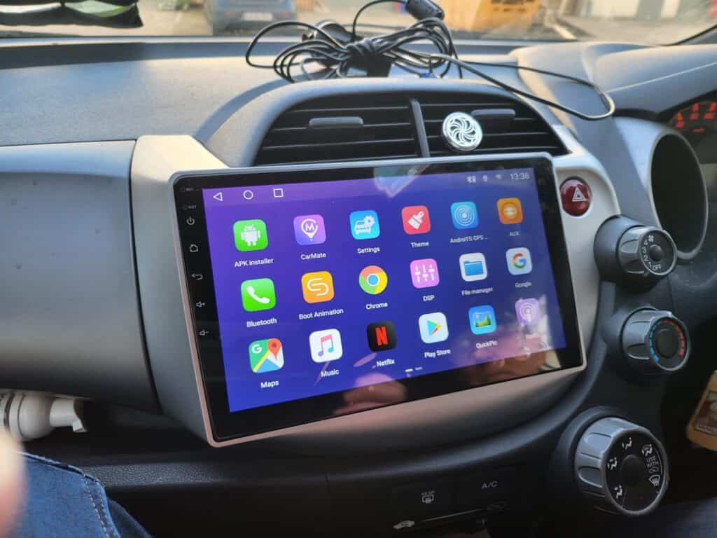 Android car stereo with CarPlay system installed in vehicle dashboard.
