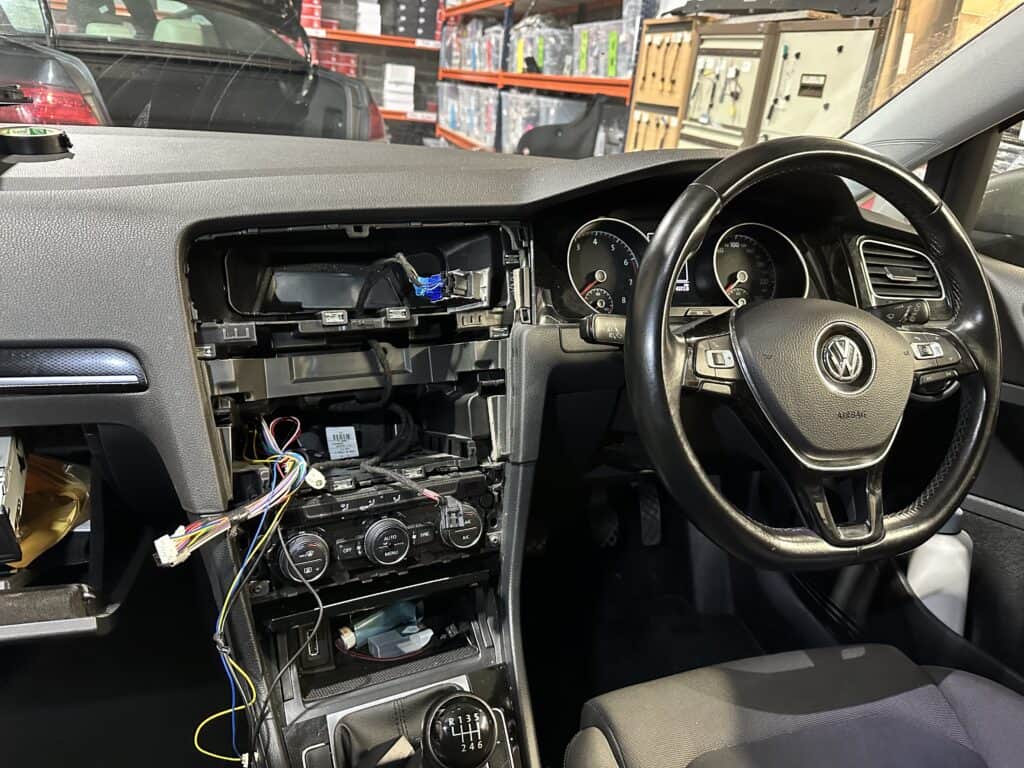 Car Audio Installation 1 Broken car stereo dashboard with exposed wiring and disassembled parts.