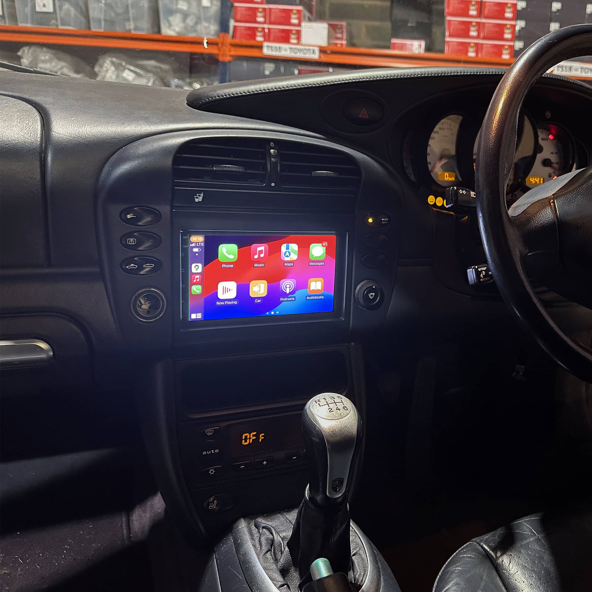 Android car stereo displaying Apple CarPlay interface inside a vehicle.