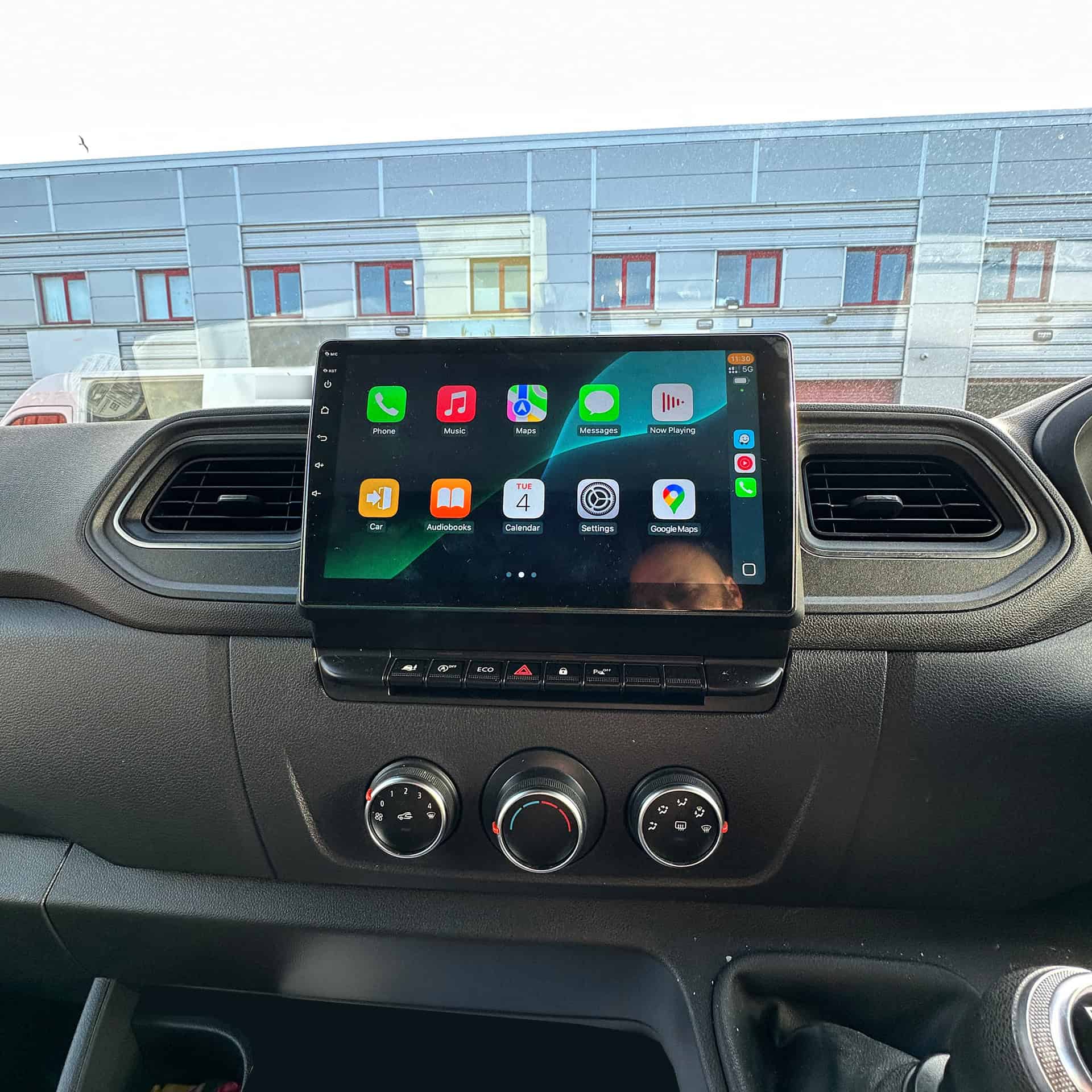 Android car radio touchscreen with CarPlay system installed in vehicle dashboard.