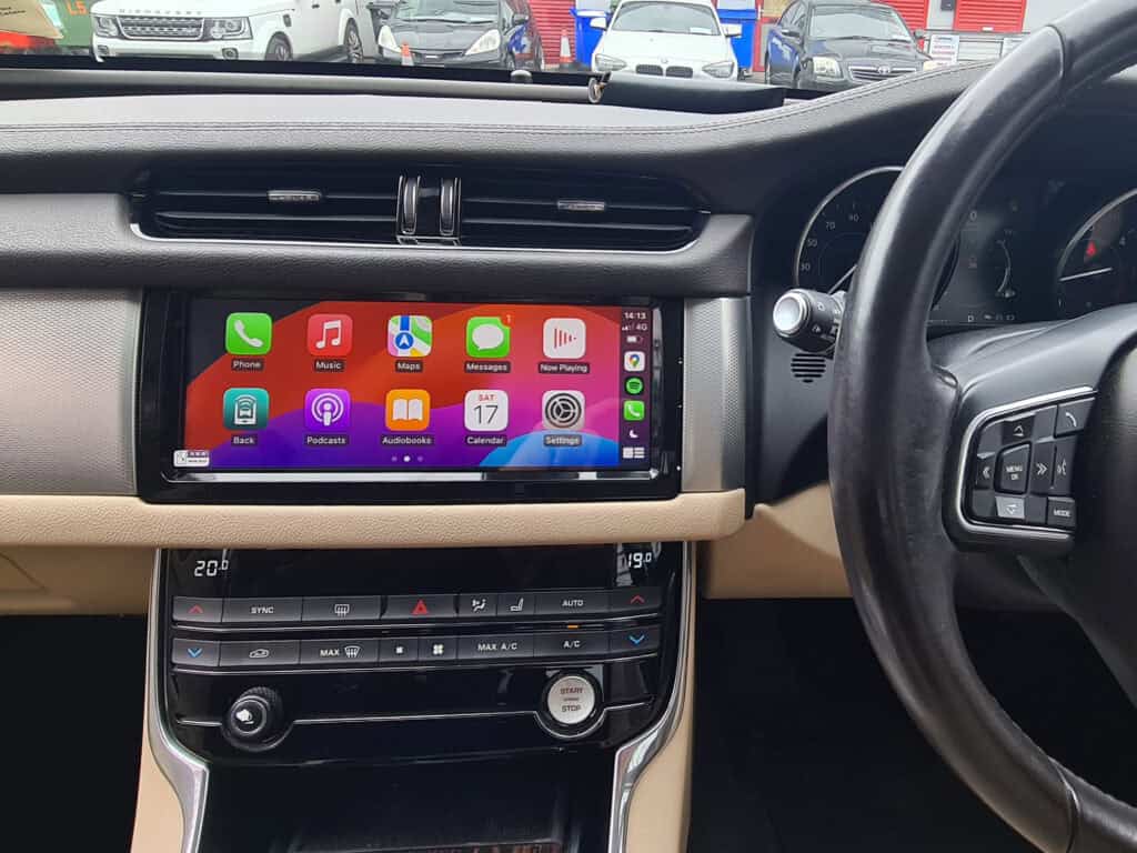Android car infotainment system with Apple CarPlay, touchscreen display in vehicle dashboard.
