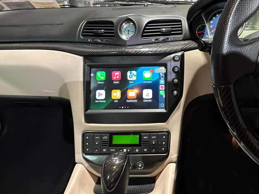 Android car stereo with CarPlay system installed in a vehicle dashboard.