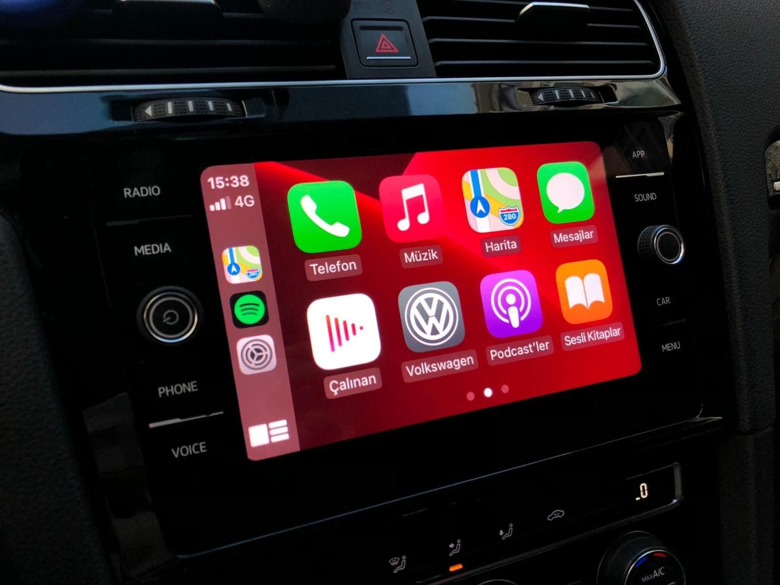 Smartphone connected to a Volkswagen car infotainment system with Apple CarPlay interface.